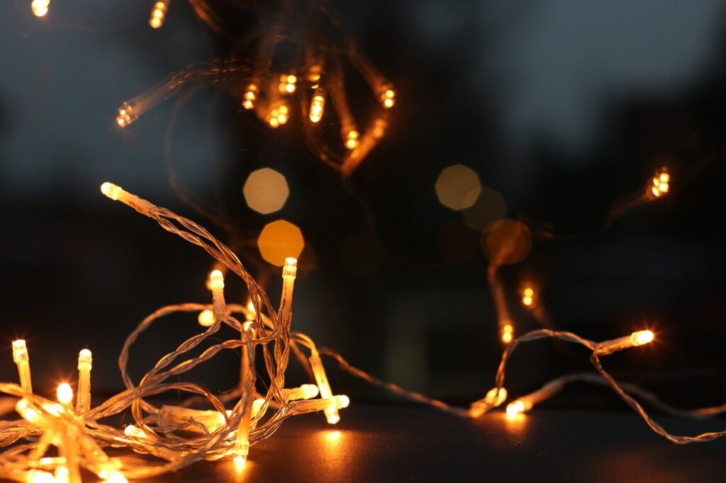 Christmas lights on a table in the dark.