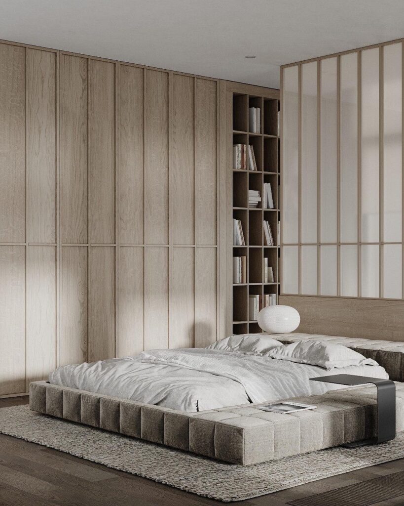 A modern bedroom with wooden walls and a large bed.