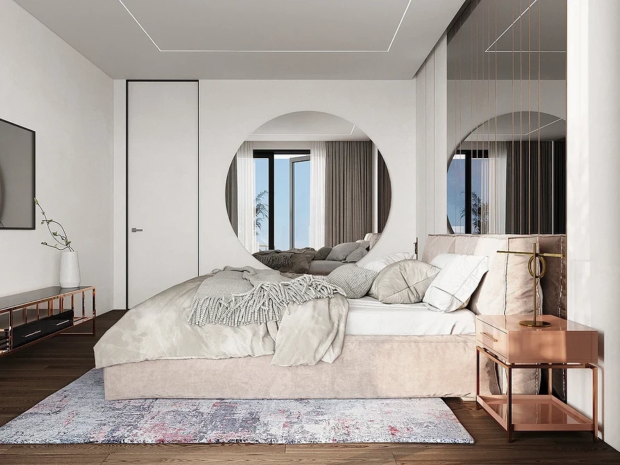 A modern bedroom with a bed and mirrors.