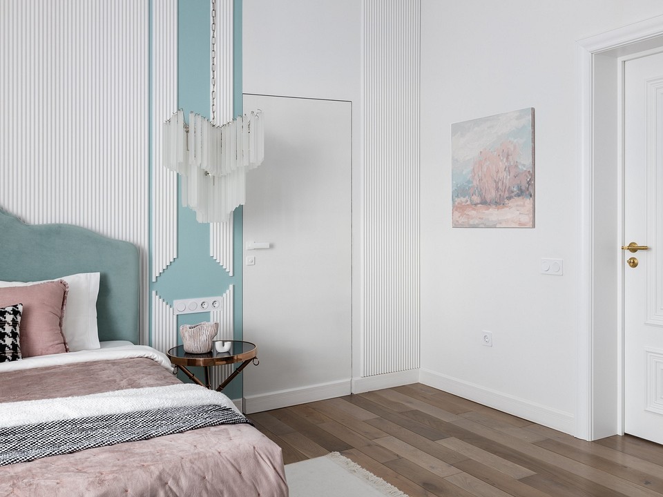 A bedroom with white walls and a pink headboard.