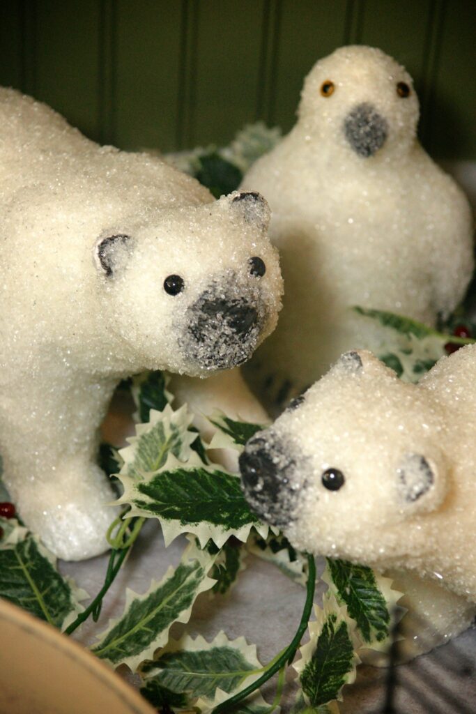 Three polar bears on a table.