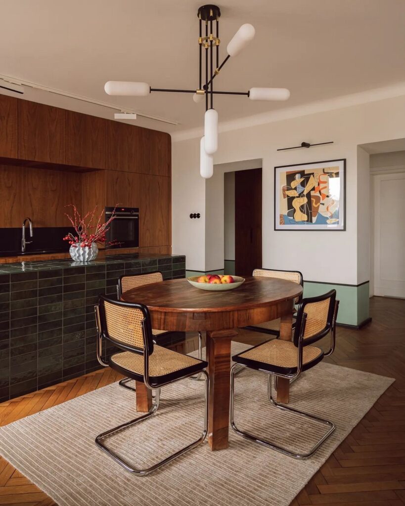 A dining room with a wooden table and chairs.