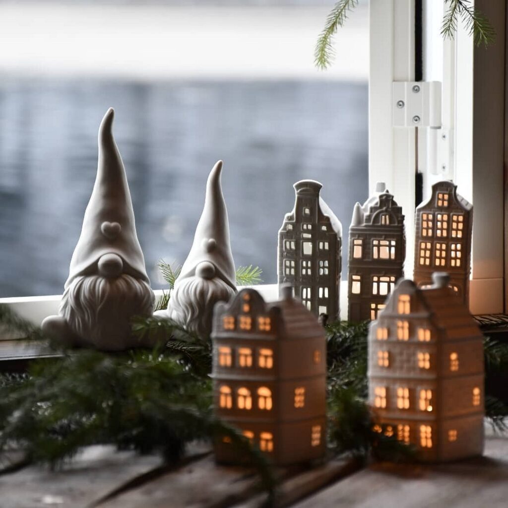 Christmas gnome figurines on a window sill.