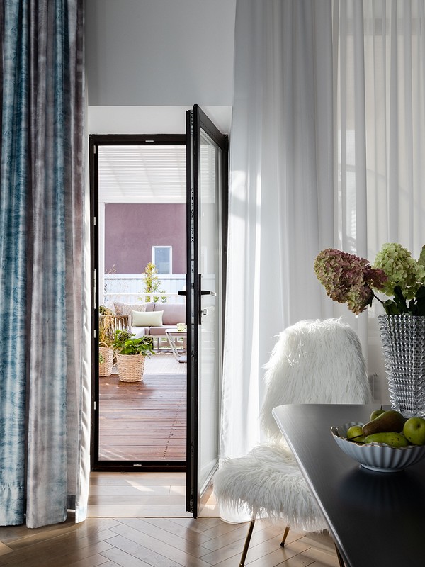 A living room with curtains and a table.