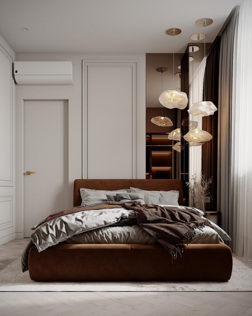 A bedroom with a brown bed and white walls.