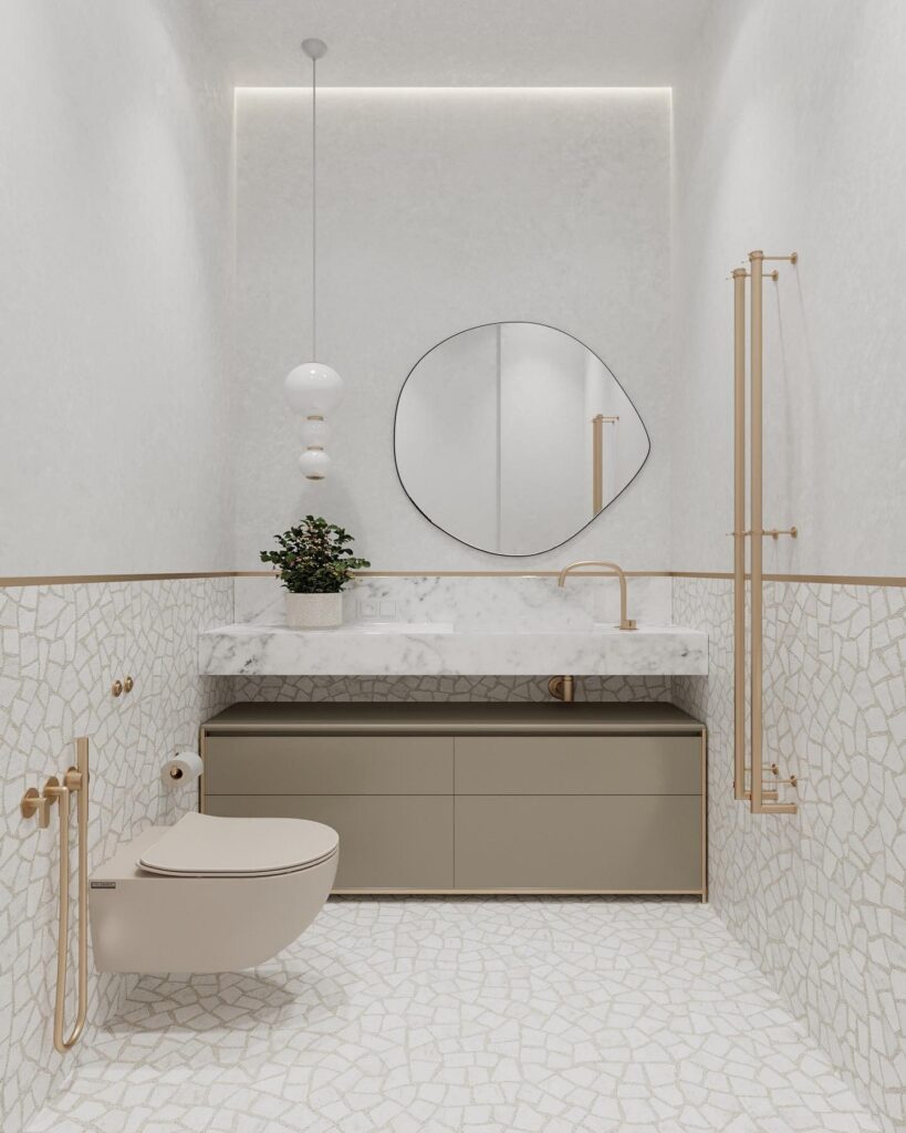 A modern bathroom with white tile and gold accents.