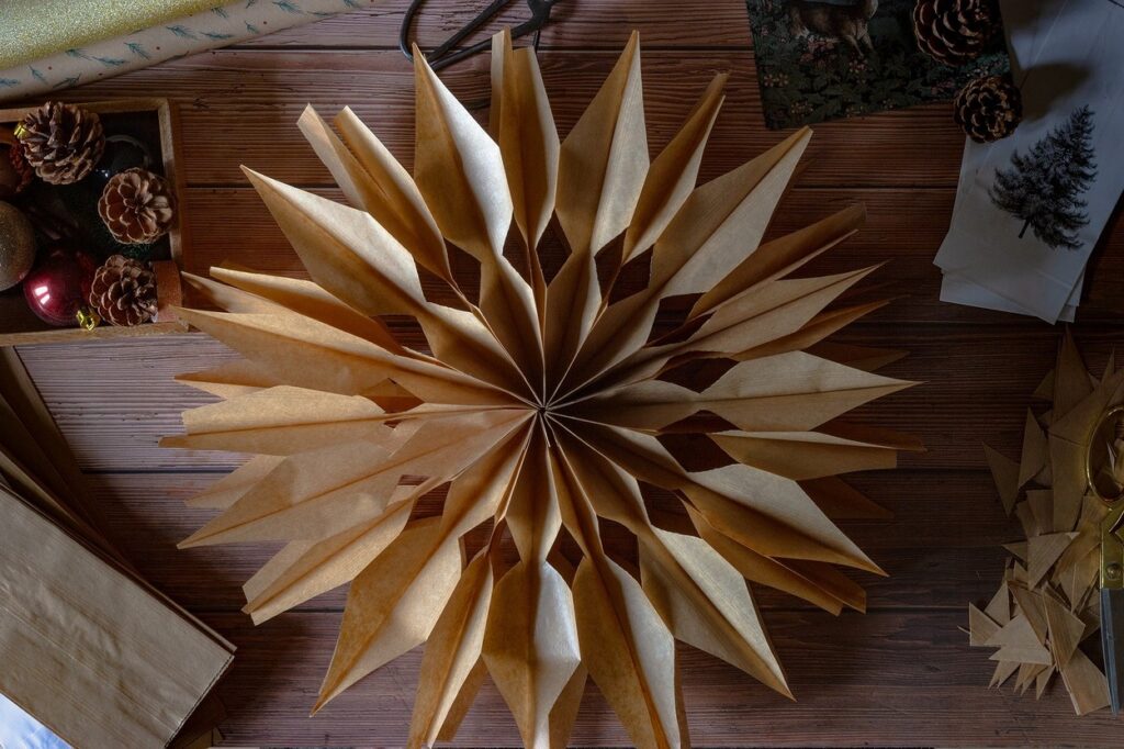 A christmas star made out of paper on a wooden table.