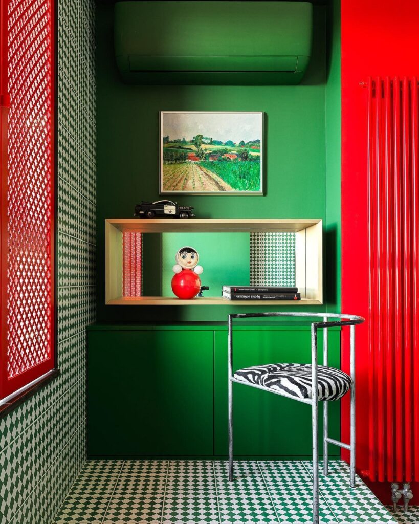 A room with red and green walls and a zebra print rug.