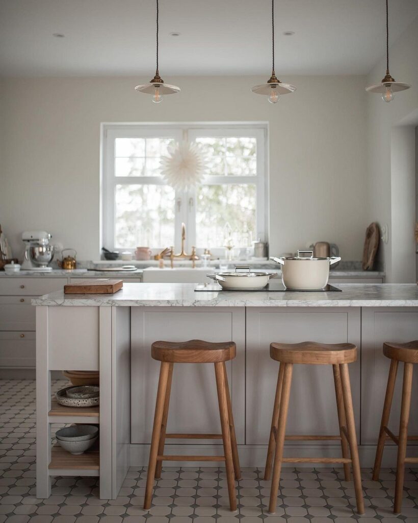 A kitchen with wooden stools and a marble counter top.