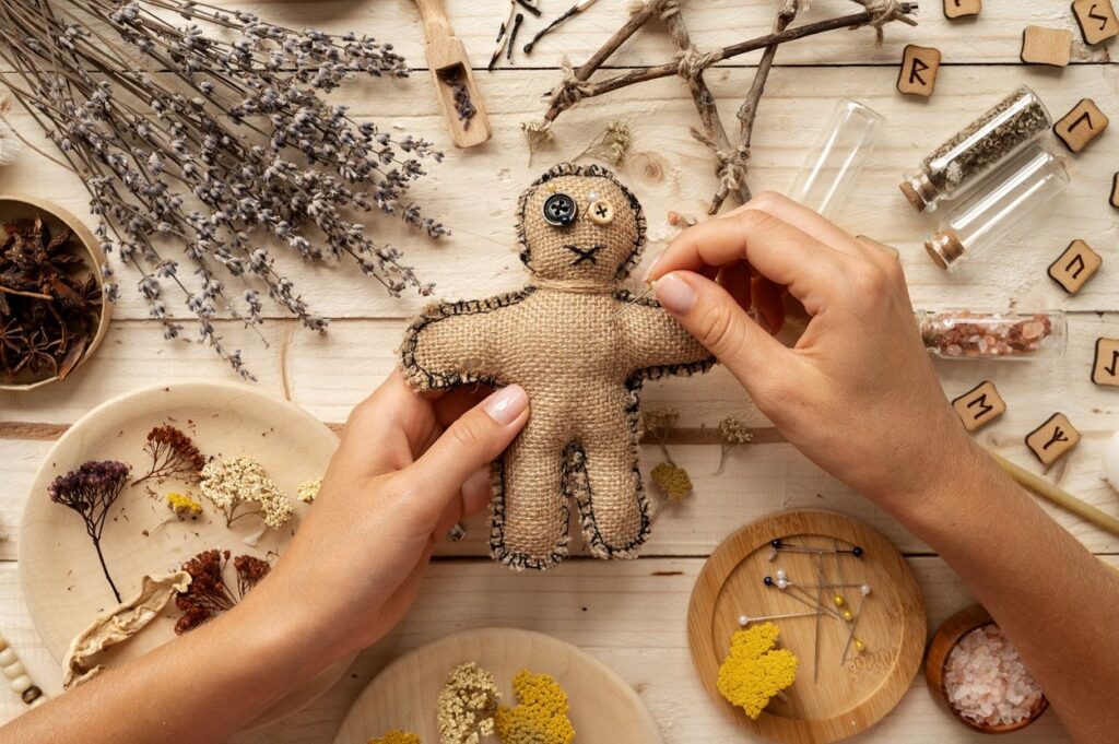 A person is making a stuffed toy with herbs on a wooden table.