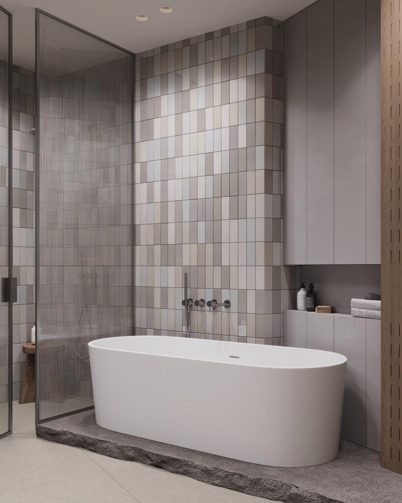 A modern bathroom with tiled walls and a bathtub.