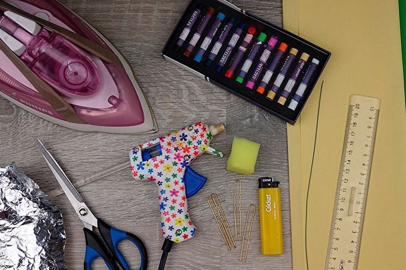 A variety of craft supplies are laid out on a table.