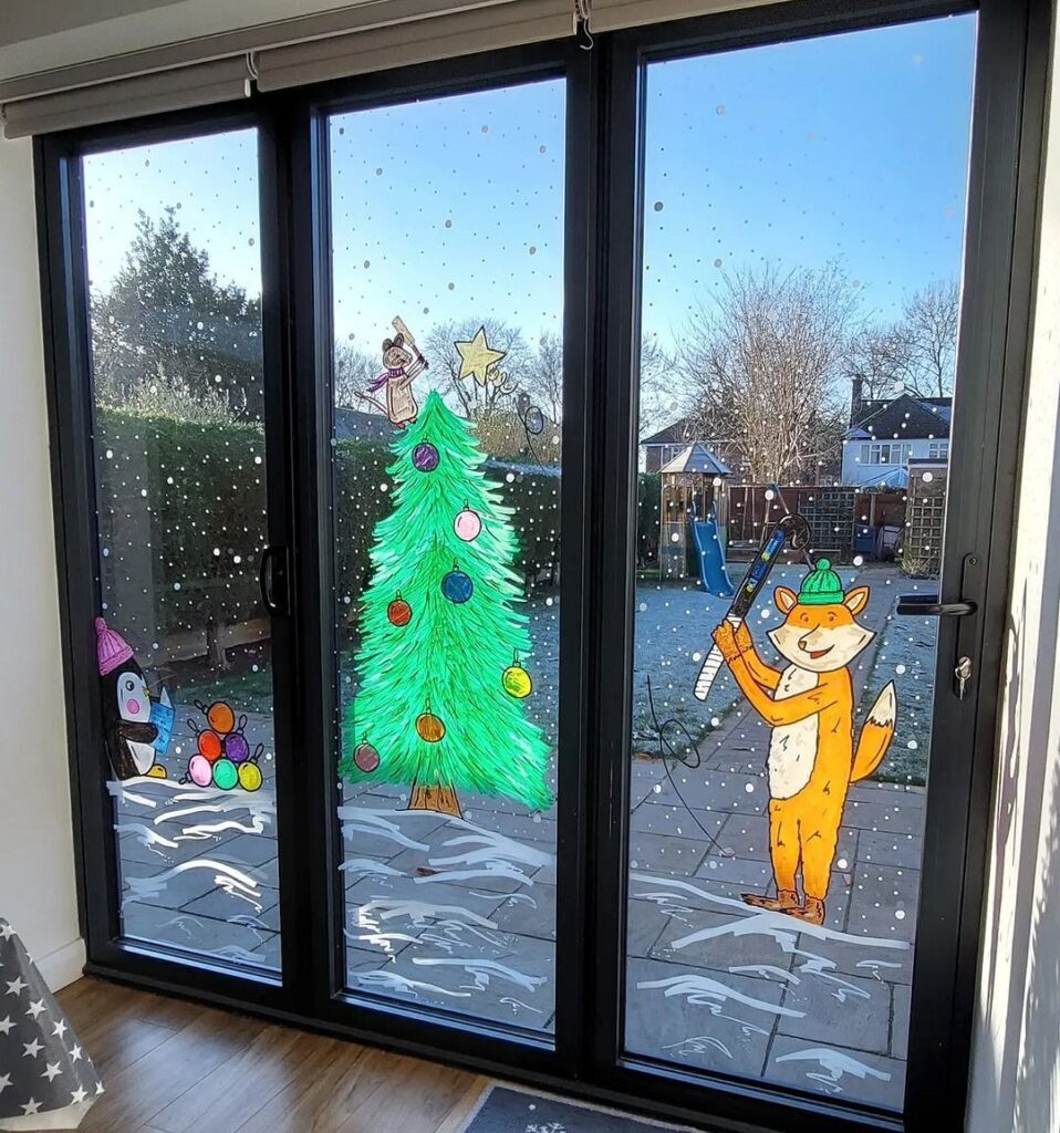 A glass door with a christmas tree and a dog on it.