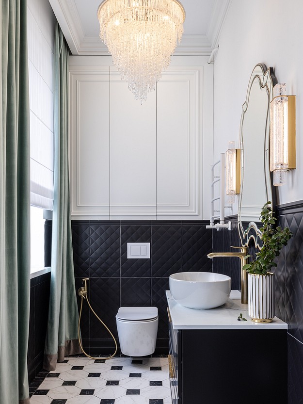 A black and white bathroom with a chandelier.