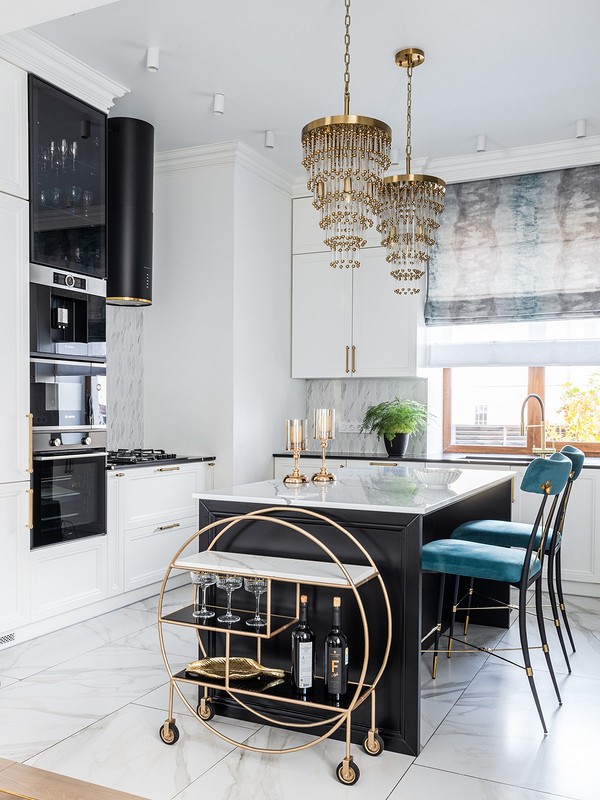 A black and white kitchen with gold accents.