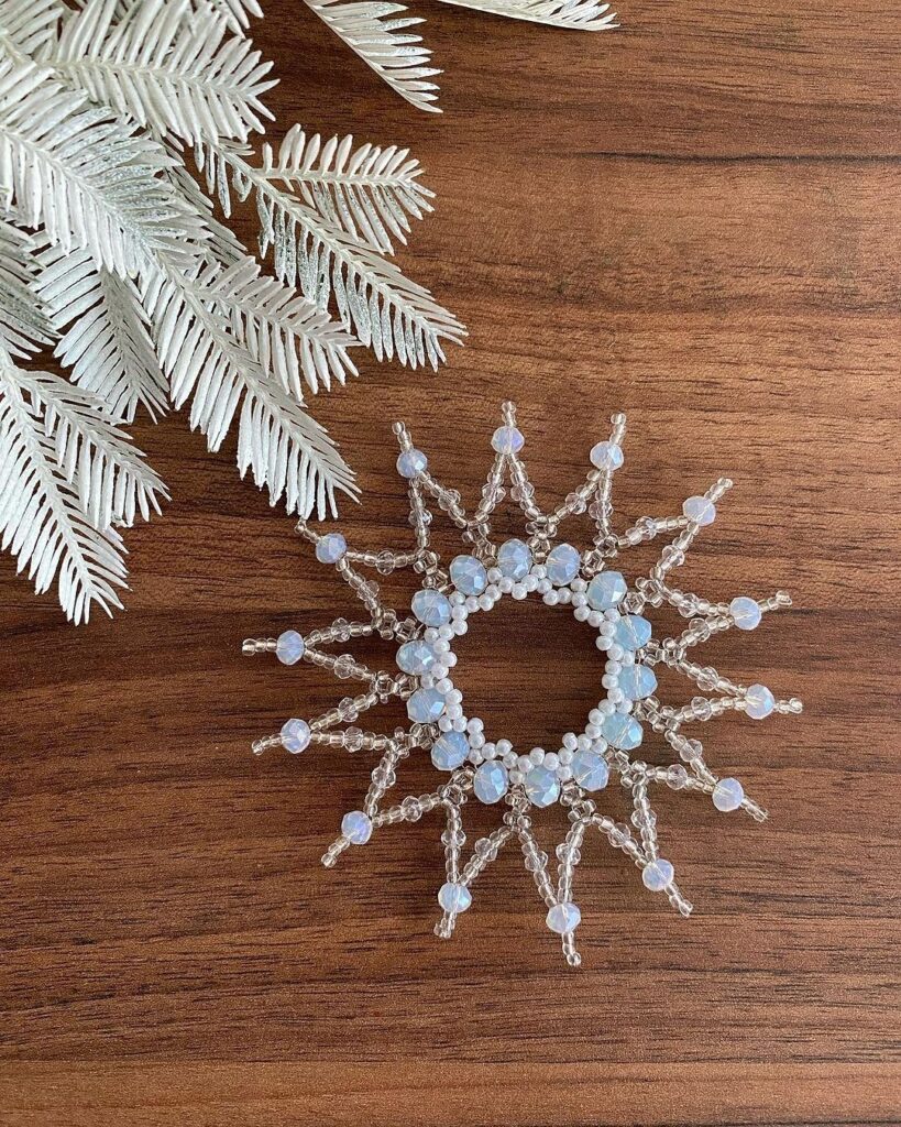 A snowflake brooch on a wooden table.