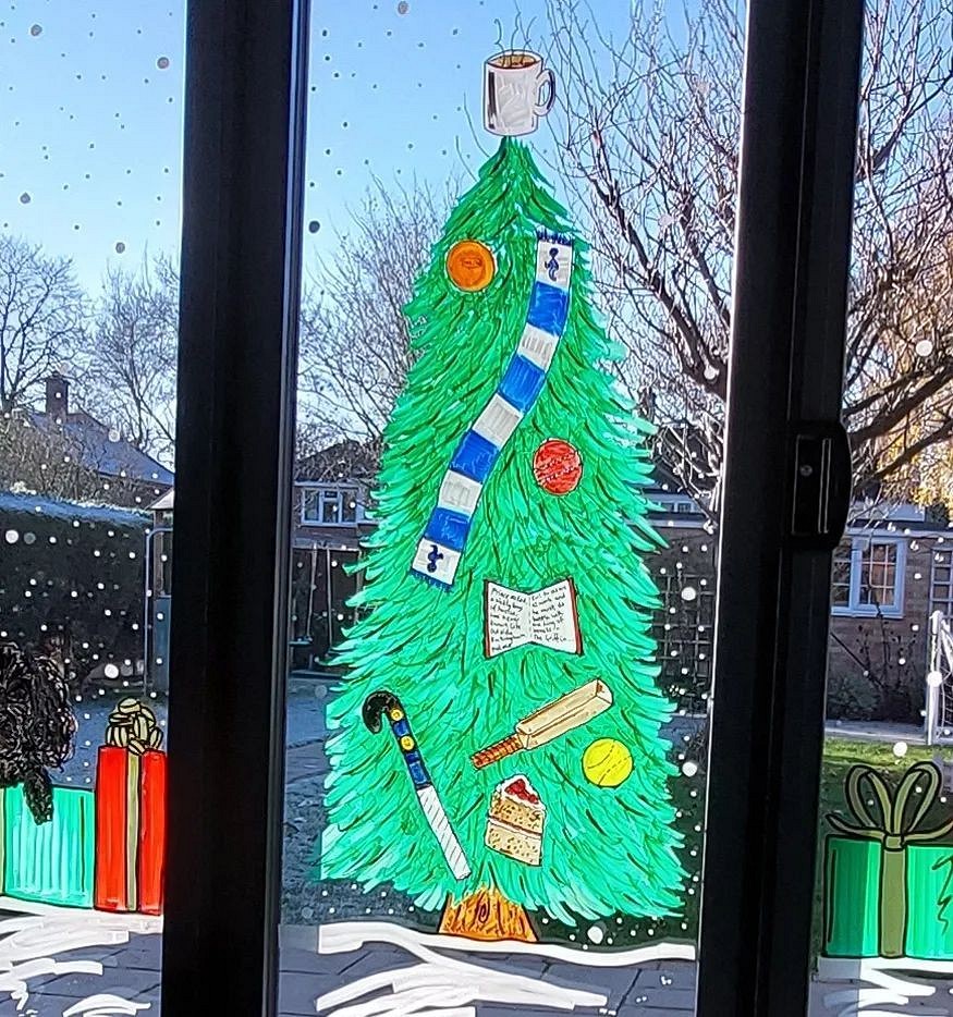 A window with a christmas tree on it.