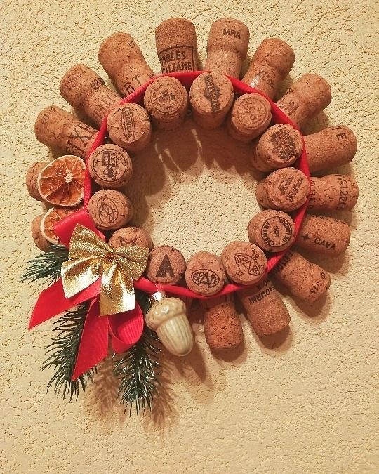 A wine cork wreath hanging on a wall.