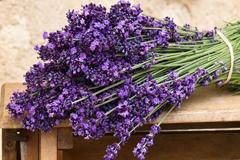 A bunch of lavender flowers on a wooden table.