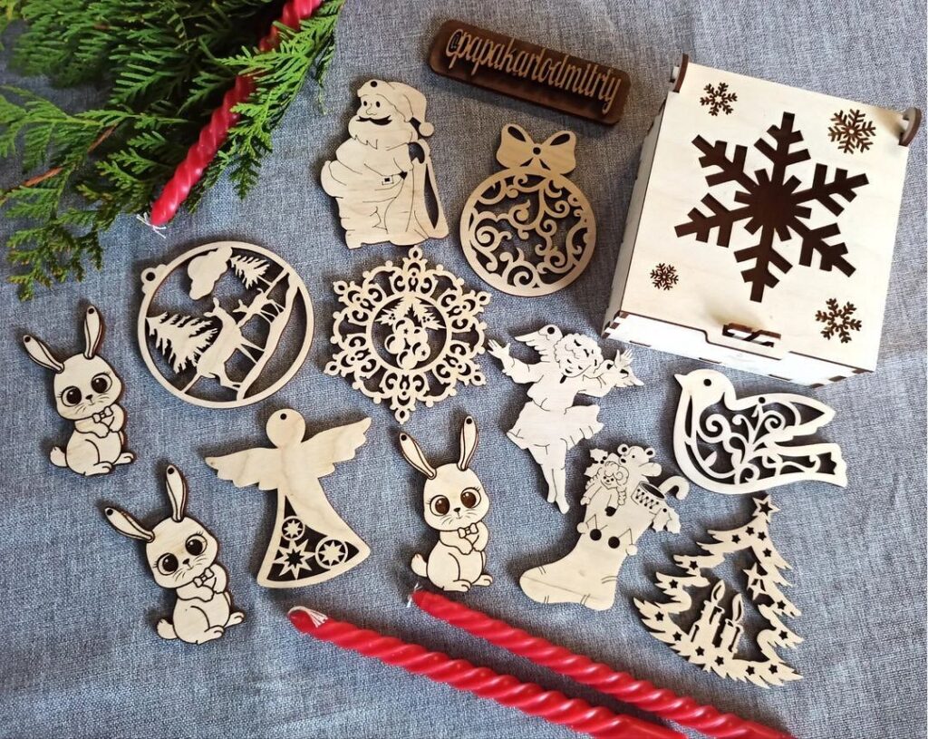 A set of wooden christmas ornaments and candles on a table.