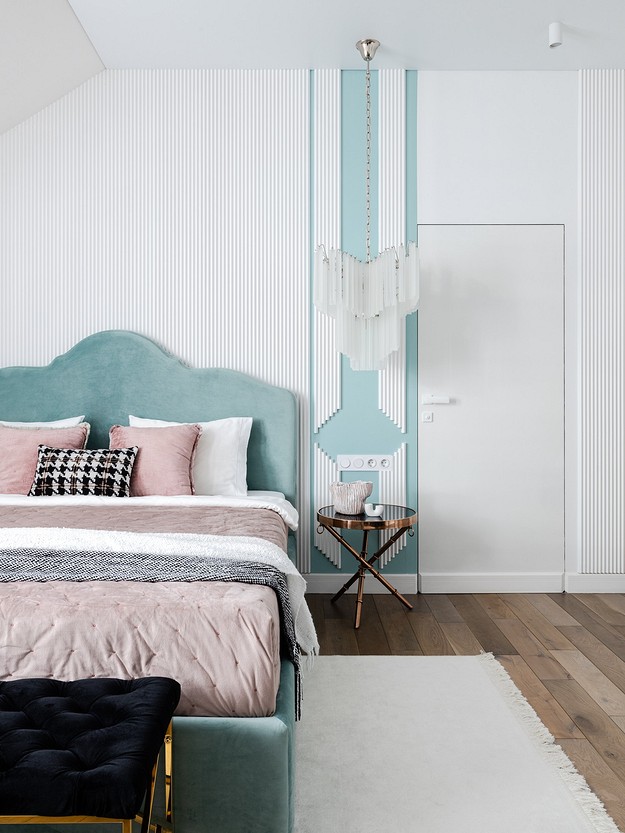 A blue and white bedroom with a pink bed.