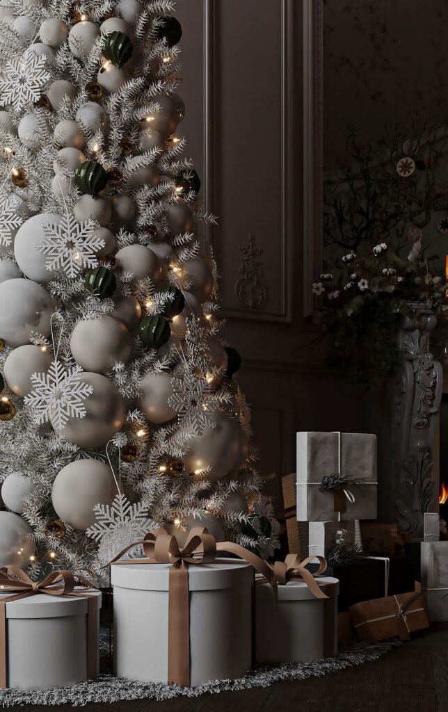 A white christmas tree in front of a fireplace.