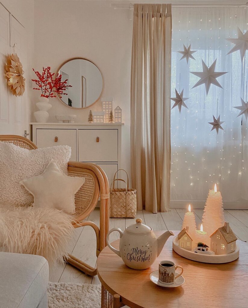 A living room decorated for christmas with candles and stars.