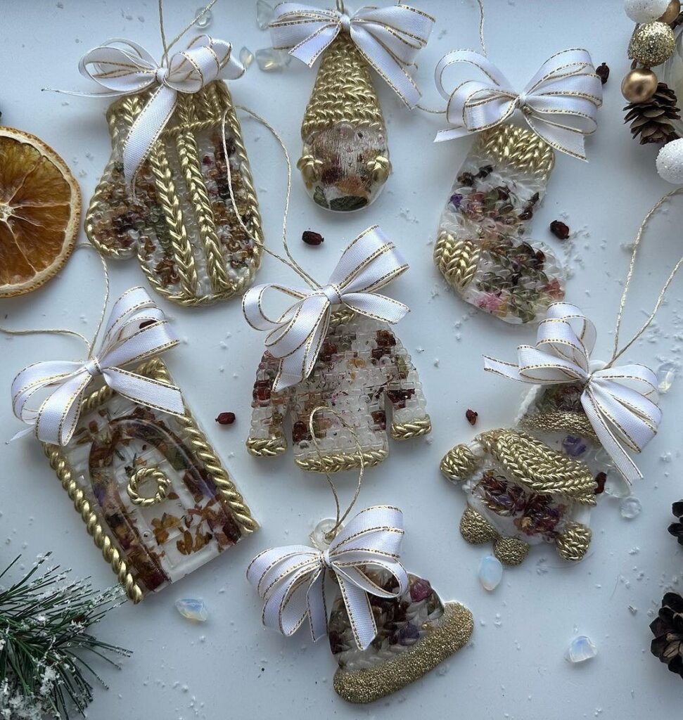 A group of christmas ornaments with ribbons and oranges.