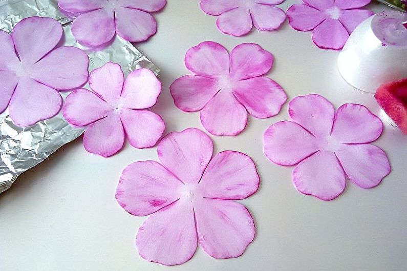 A bunch of pink flowers on a piece of foil.