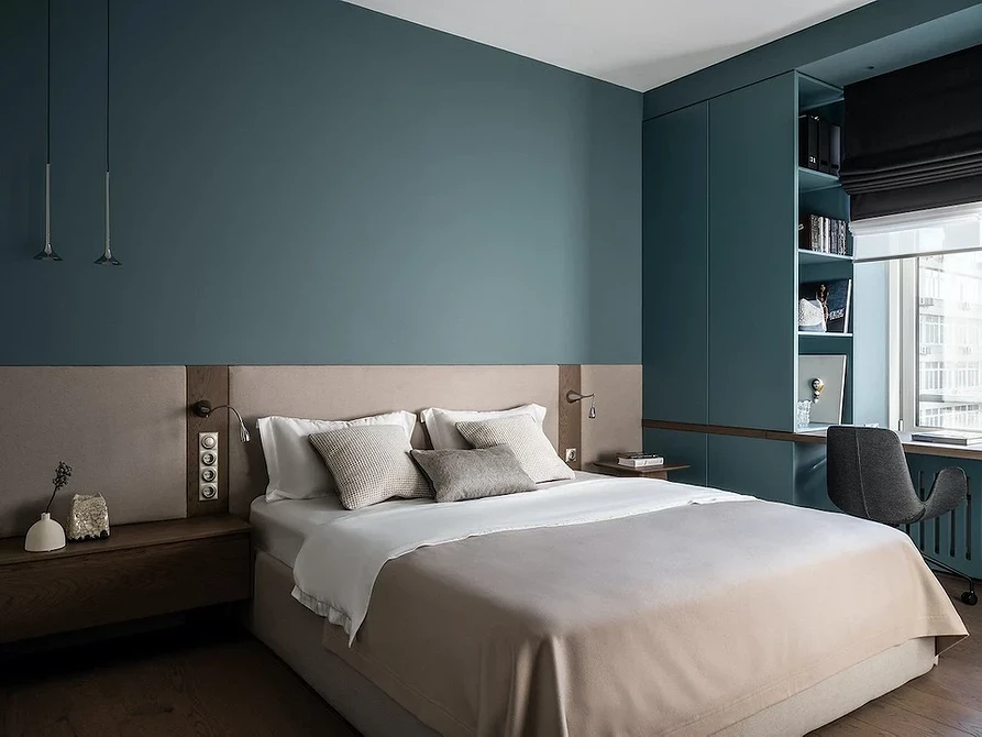 A bedroom with blue walls and wooden floors.