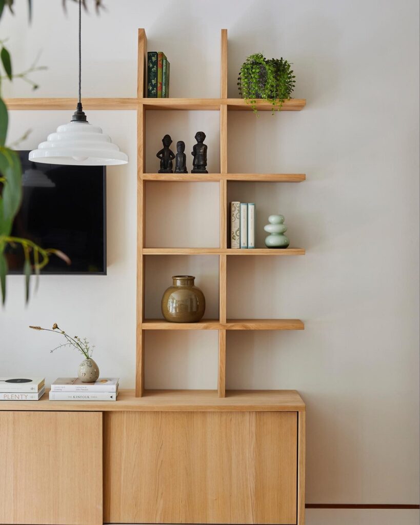 A living room with bookshelves and a tv.