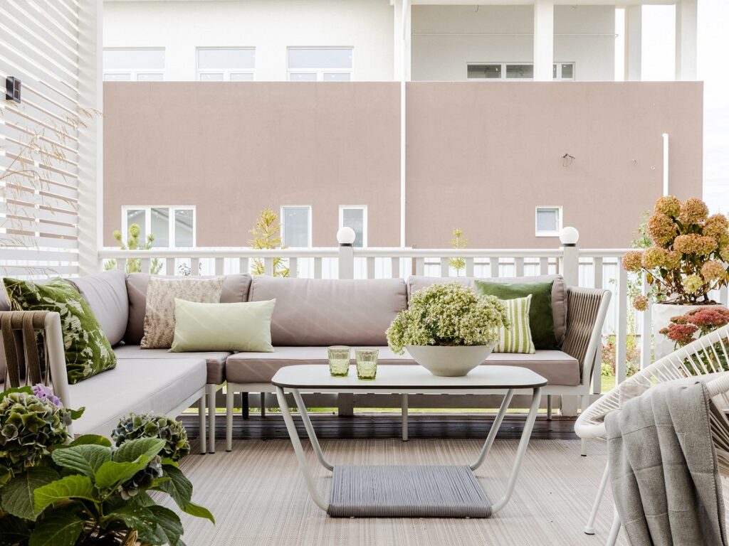 A white couch on a balcony.