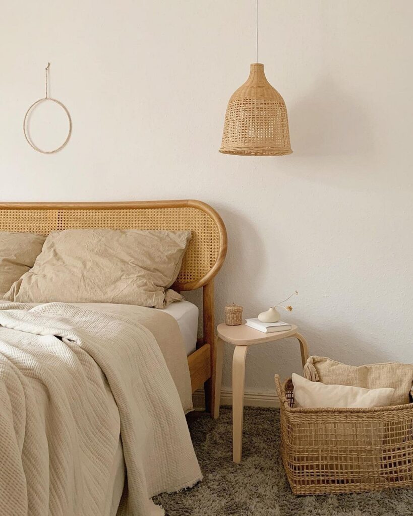 A bedroom with a bed and a wicker basket.