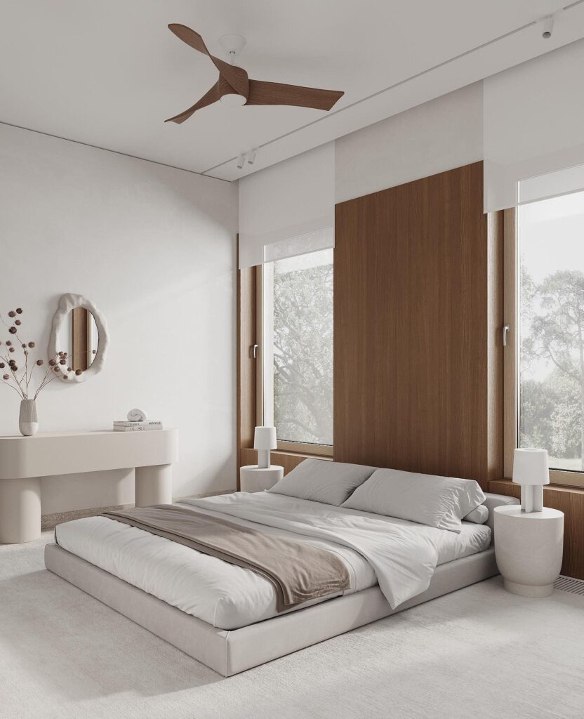 A modern bedroom with white walls and a ceiling fan.