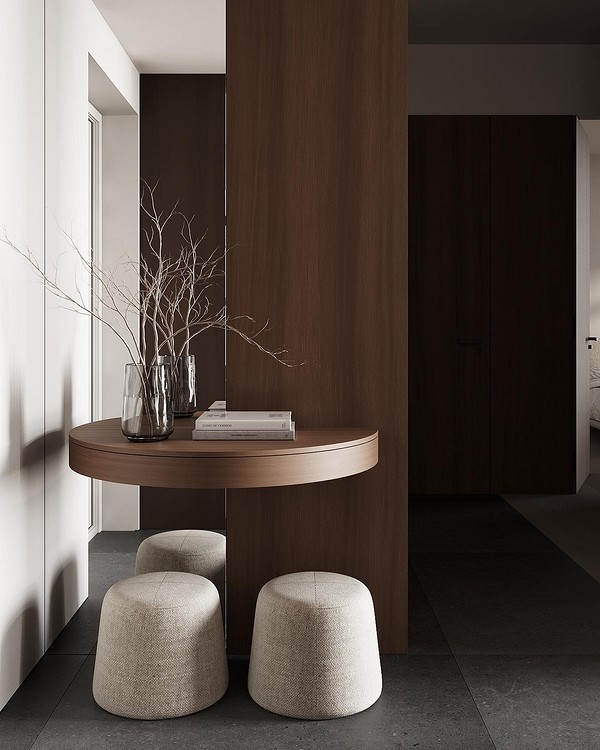 A modern entryway with a wooden table and two stools.