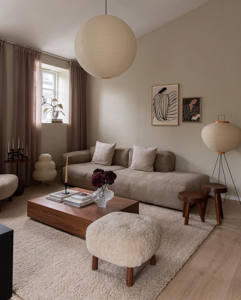 A living room with a beige couch and a coffee table.