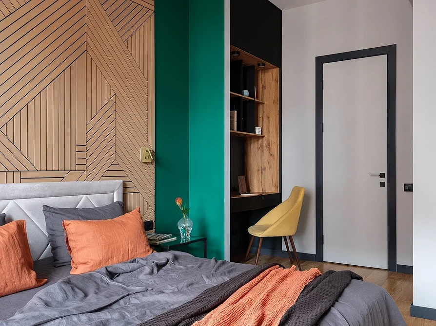 A bedroom with green and orange accents.