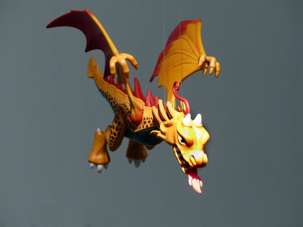 A toy dragon flying in the air.