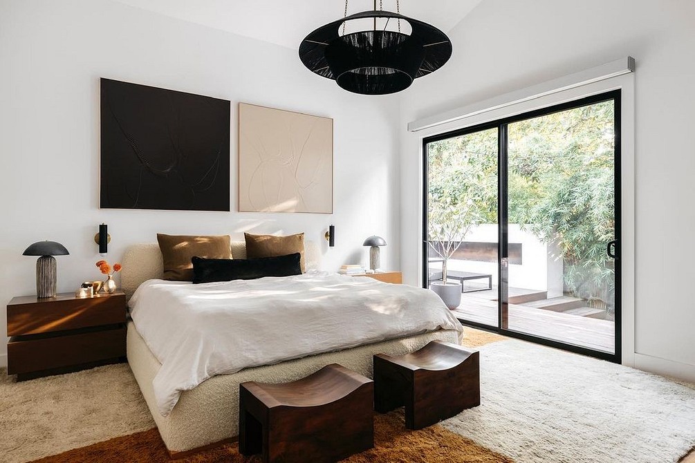 A bedroom with a large bed and a sliding glass door.