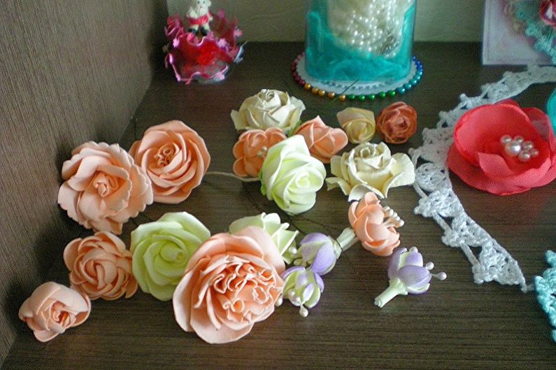 A table with paper flowers and lace on it.