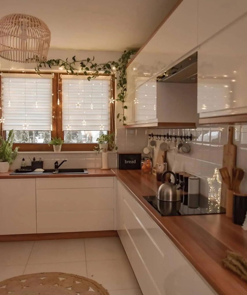 A kitchen with white cabinets and wooden counter tops.