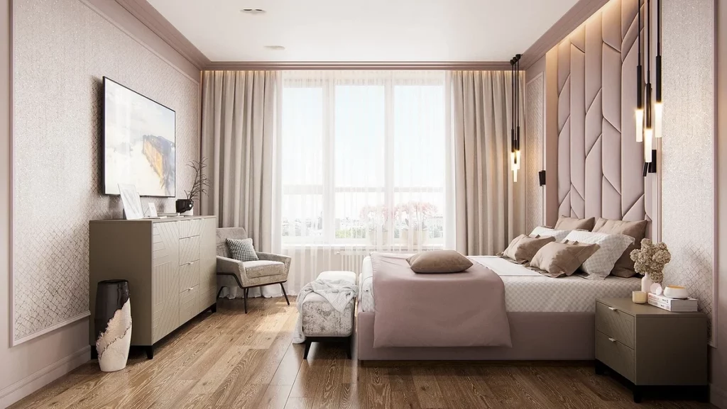 A bedroom with a pink bed and wooden floors.