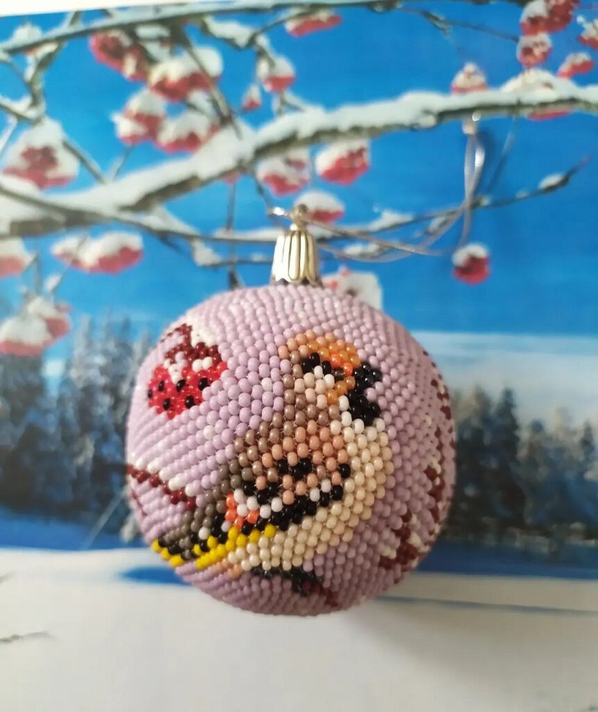 A christmas ornament with a bird on it.