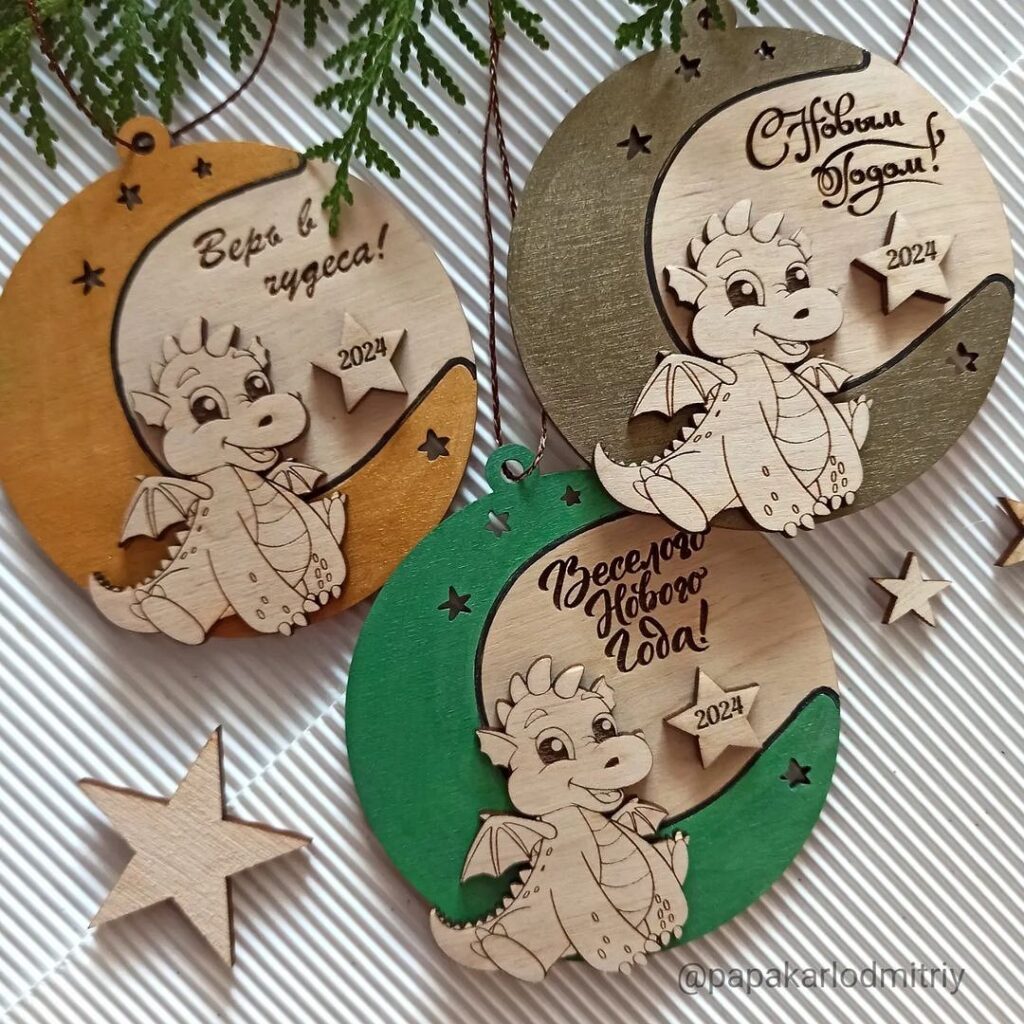 Three wooden ornaments with a dragon on them.