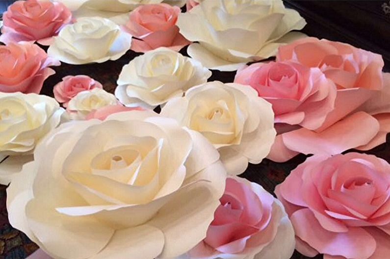 A bunch of paper roses are arranged on a table.