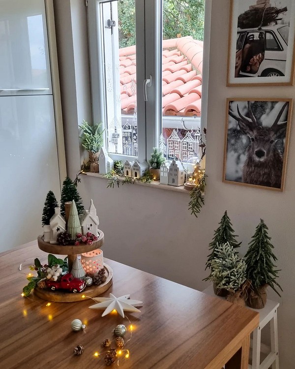 A wooden table with christmas decorations on it.