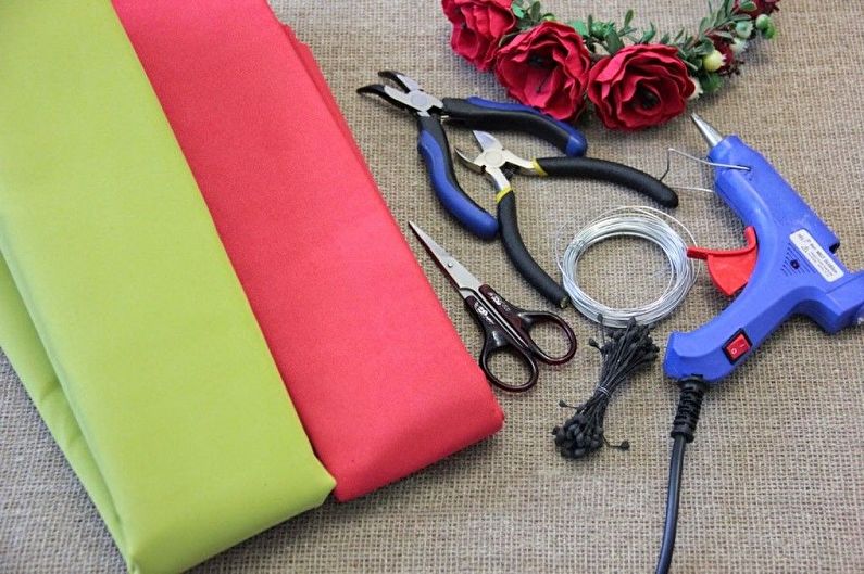 A red and green fabric with scissors and a pair of scissors.